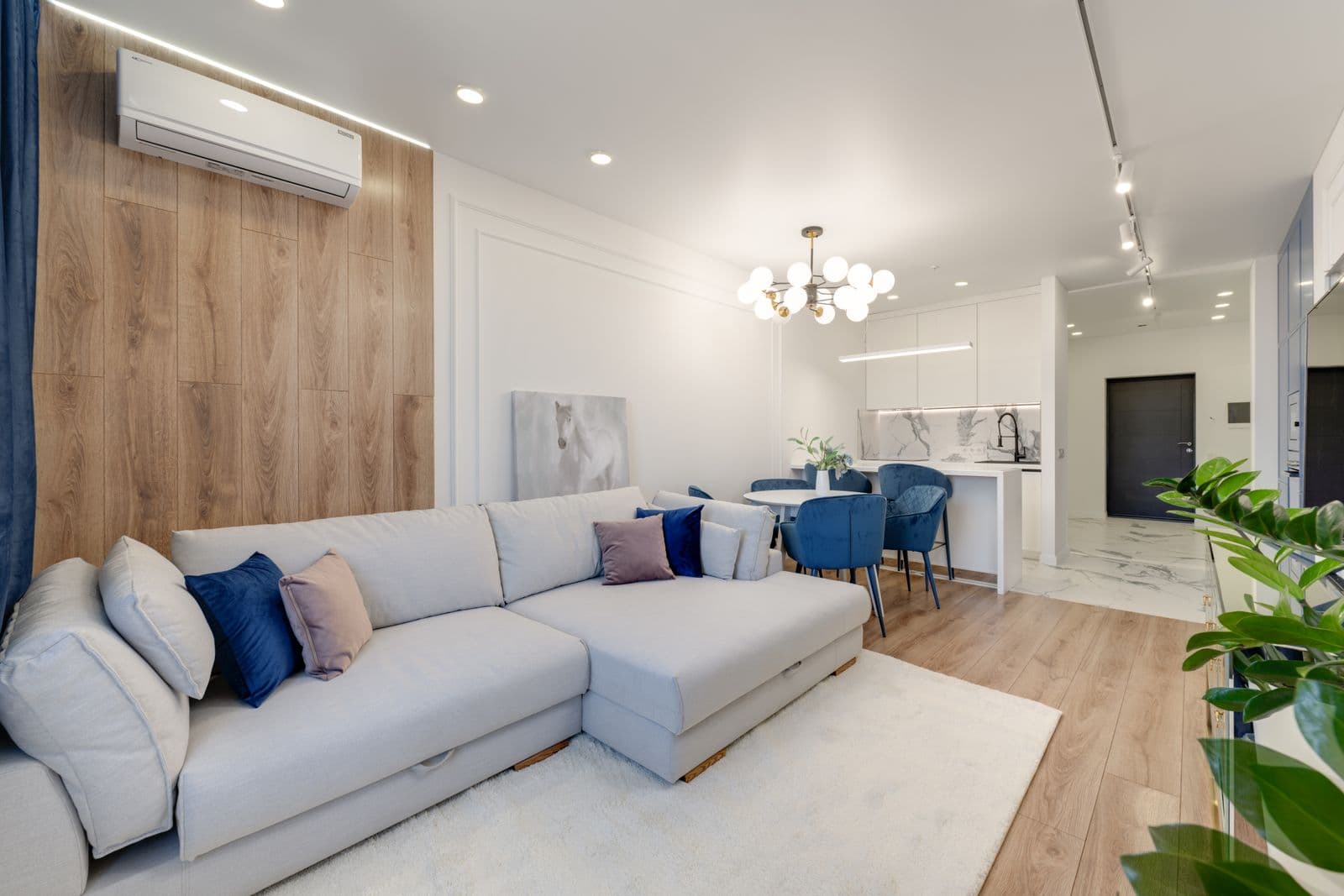 A wall-mounted air-to-air heat pump indoor unit in a modern UK living room
